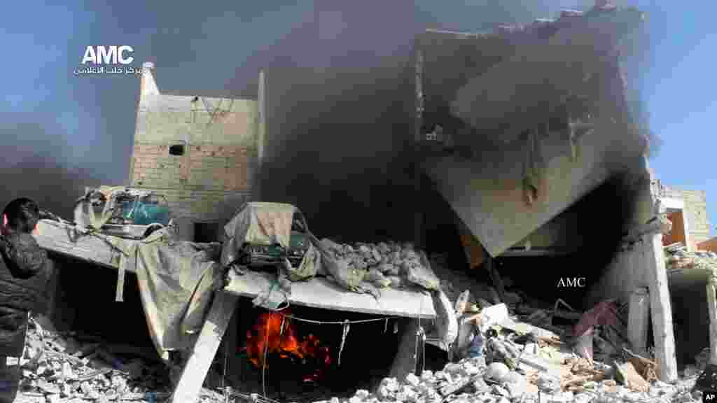 This citizen journalism image shows a destroyed building after a Syrian air strike in Aleppo, Dec. 22, 2013.