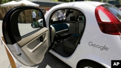 FILE - A Google self-driving car is on display at Google's I/O conference in Mountain View, Calif., May 18, 2016. Cars with no steering wheel, no pedals and nobody at all inside could be driving themselves on California roads by the end of 2017, under proposed new rules that would give a powerful boost to the technology from the nation's most populous state.