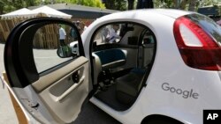 FILE - A Google self-driving car is on display at Google's I/O conference in Mountain View, Calif., May 18, 2016. Cars with no steering wheel, no pedals and nobody at all inside could be driving themselves on California roads by the end of 2017, under proposed new rules.