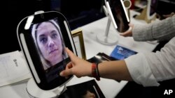 The HiMirror Mini, an internet-connected smart mirror with Amazon's Alexa, is shown during CES Unveiled at CES International in January. Retailers are now trying to find out how they can use smart mirrors to sell products. (AP Photo/Jae C. Hong)