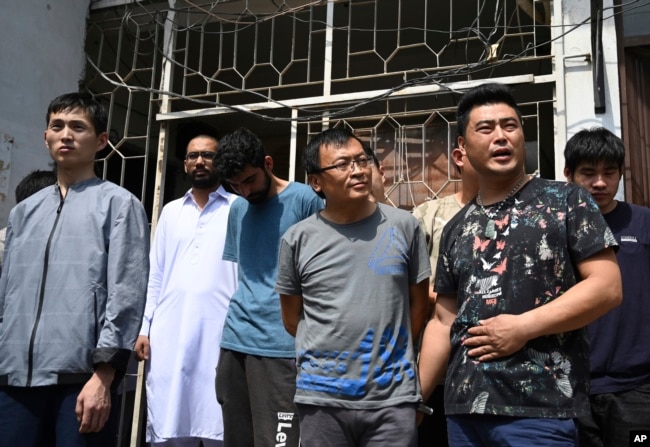 Detained Chinese nationals whose alleged involvement in a trafficking gang to lure Pakistani women into fake marriages, arrive at a court in Islamabad, Pakistan, Thursday, May 9, 2019.