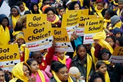 FILE - Several hundred students, parents, teachers and elected officials, participate in a school choice rally, part of the National School Choice Week, on the steps of the Capitol in Jackson, Miss., Tuesday, Jan. 22, 2019. (AP Photo/Rogelio V. Solis)