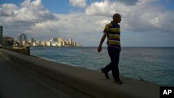 A man walks along the sea wall of Havana, Cuba, Jan. 13, 2017. 
