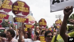 Protesters march towards the Chinese consulate during a rally in Manila's financial district of Makati, Philippines, May 11, 2012.