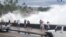 Incoming waves tower over bystanders in Kona, Hawaii, U.S., Aug. 23, 2018 in this still image from video obtained from social media. (Ryan Leinback)