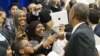 FILE - President Barack Obama greets children from Al-Rahmah school and guests during his visit to the Islamic Society of Baltimore in Baltimore, Maryland, Feb. 3, 2016. In his Eid-al-Fitr message issued Wednesday he called on fellow citizens to "stand in solidarity and protect one another."