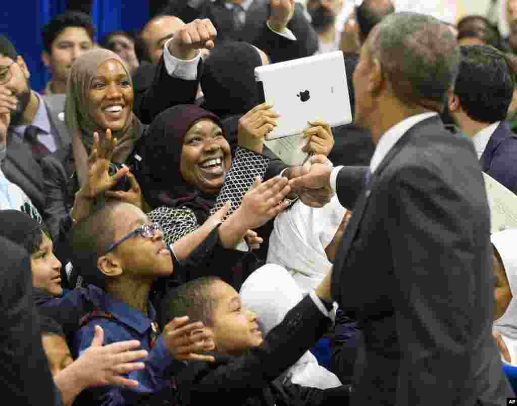 President Barack Obama greets children from Al-Rahmah school and other guests during his visit to the Islamic Society of Baltimore in Baltimore, Maryland, Feb. 3, 2016.