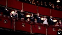 FILE - President Barack Obama (R) and first lady Michelle Obama (2-R) are seen with some of last year's Kennedy Center Honors recipients during the Honors Gala at the Kennedy Center in Washington, Dec. 7, 2014.