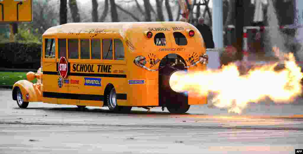 Car designer Gerd Habermann launches his &quot;School Bus Jet&quot; vehicle during a preview of the Essen Motor Show in Essen, western Germany.