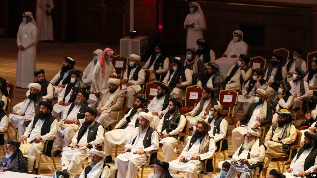 FILE - Members of the Taliban delegation attend the opening session of the peace talks between the Afghan government and the Taliban in the Qatari capital Doha, Sept. 12, 2020. 