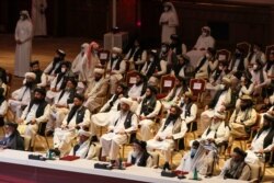 FILE - Members of the Taliban delegation attend the opening session of the peace talks between the Afghan government and the Taliban in the Qatari capital Doha, Sept. 12, 2020.