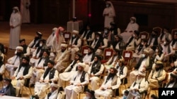 FILE - Members of the Taliban delegation attend the opening session of the peace talks between the Afghan government and the Taliban in the Qatari capital Doha, Sept. 12, 2020. 