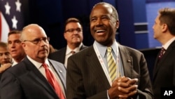 FILE - Dr. Ben Carson, center, waits for the the third debate between Democratic presidential nominee Hillary Clinton and Republican presidential nominee Donald Trump during the third presidential at UNLV in Las Vegas