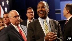 FILE - Dr. Ben Carson, center, waits for the the third debate between Democratic presidential nominee Hillary Clinton and Republican presidential nominee Donald Trump during the third presidential at UNLV in Las Vegas