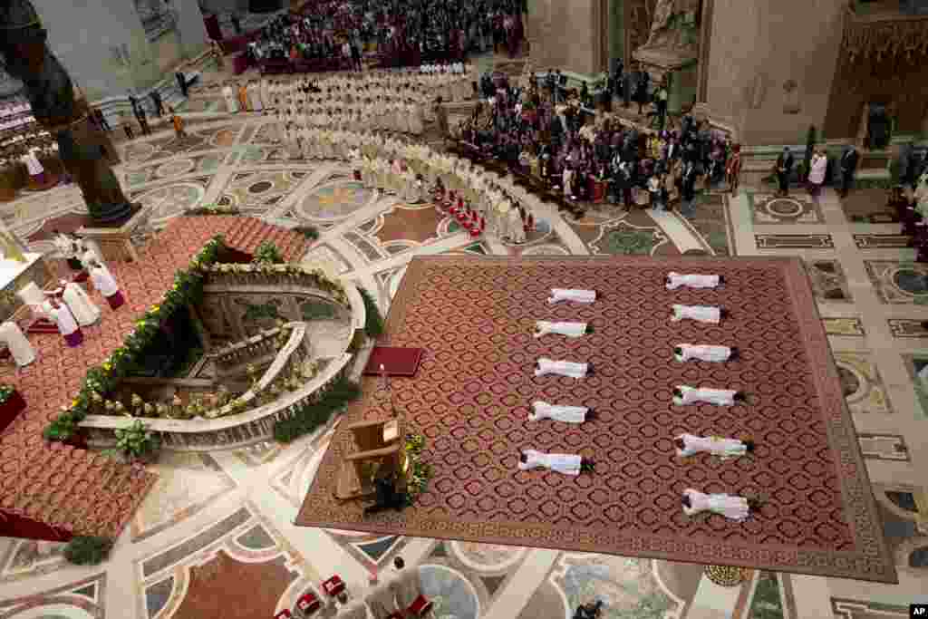 Eleven new priests lay on the ground during a ceremony in which Pope Francis ordained them, in St. Peter&#39;s Basilica at the Vatican.