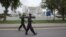 Paramilitary soldiers walk past the Supreme Court building in Islamabad, August 8, 2012. 