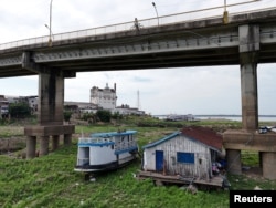 A drone view shows floating houses stranded on the Rio Negro as the river reached its lowest point in its history during the most widespread drought Brazil has experienced since records began in 1950, in Manaus, Amazonas state, Brazil Oct. 4, 2024.