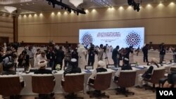FILE - Media representatives are seen filming and taking photographs at the start of an intra-Afghan dialogue session, in Doha, Qatar, July 7, 2019. (A. Tanzeem/VOA)