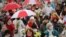 Belarusian women with umbrellas in the colors of the old Belarusian national flag take part in an opposition rally to protest the official presidential election results in Minsk, Belarus, Oct. 24, 2020.