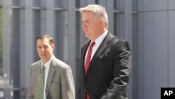 Utah U.S. Attorney John W. Huber, right, walks from the federal courthouse after attorneys made their closing arguments Thursday, Aug. 29, 2019, Salt Lake City.