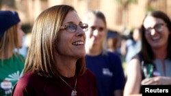 FILE - Republican U.S. Senate candidate Rep. Martha McSally (C) talks with people waiting in line at the ASU Palo Verde West polling station during the U.S. midterm elections in Tempe, Arizona, Nov. 6, 2018. 