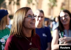 FILE - Then-Republican U.S. Senate candidate Rep. Martha McSally, center, talks with people waiting in line at the ASU Palo Verde West polling station during the U.S. midterm elections in Tempe, Arizona, U.S. Nov. 6, 2018.