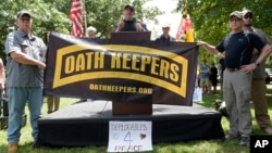 Stewart Rhodes, founder of the citizen militia group known as the Oath Keepers, center, speaks during a rally outside the White House in Washington, June 25, 2017.