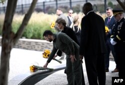Ukrainian President Volodymyr Zelensky and Ukrainian First Lady Olena Zelenska take part in a wreath laying ceremony at the 9/11 Pentagon Memorial, in Washington, DC, on September 21, 2023, with US Defense Secretary Lloyd Austin (2nd R) and Chairman of th