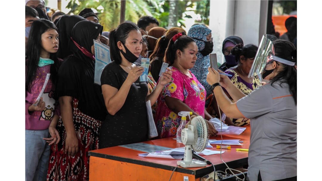 Warga menerima bantuan tunai langsung (BLT) sebesar Rp 600 ribu di tengah wabah virus corona, di Medan, Sumatra Utara, 18 Mei 2020. (Foto: AFP)