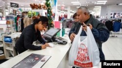 A shopper makes a purchase at the J.C. Penney department store in North Riverside, Illinois, Nov. 17, 2017. 