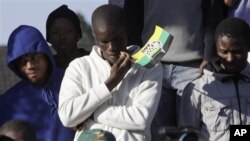 Supporters of men accused of murdering white supremacist Eugene TerreBlanche, outside Ventersdorp court, South Africa, May 22, 2012.