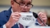 FILE - U.S. Census Bureau Director Steven Dillingham holds up his mask with the words "2020 Census" as he testifies before a House Committee on Oversight and Reform hearing on the 2020 Census​ on Capitol Hill, July 29, 2020, in Washington.