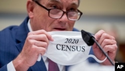 Census Bureau Director Steven Dillingham holds up his mask with the words '2020 Census' as he testifies before a House Committee on Oversight and Reform hearing on the 2020 Census​ on Capitol Hill, July 29, 2020, in Washington. 