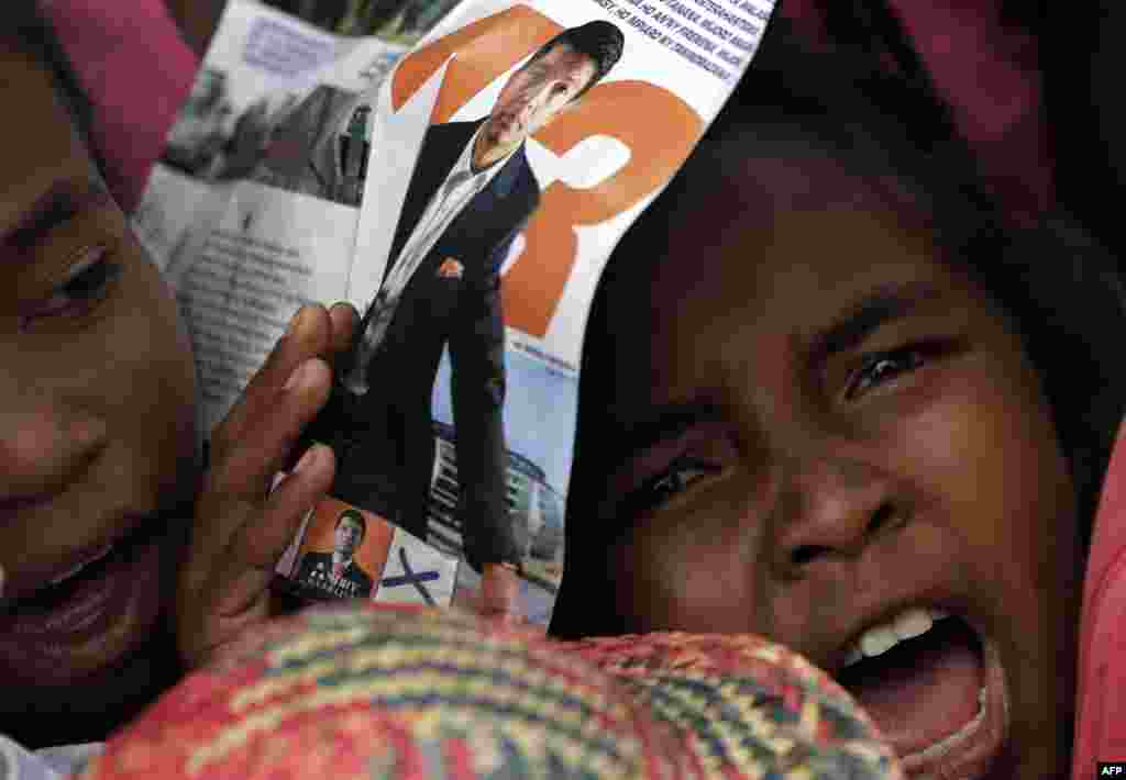 A young girl attends presidential candidate Andry Rajoelina&#39;s election rally in Antananarivo, Madagascar.