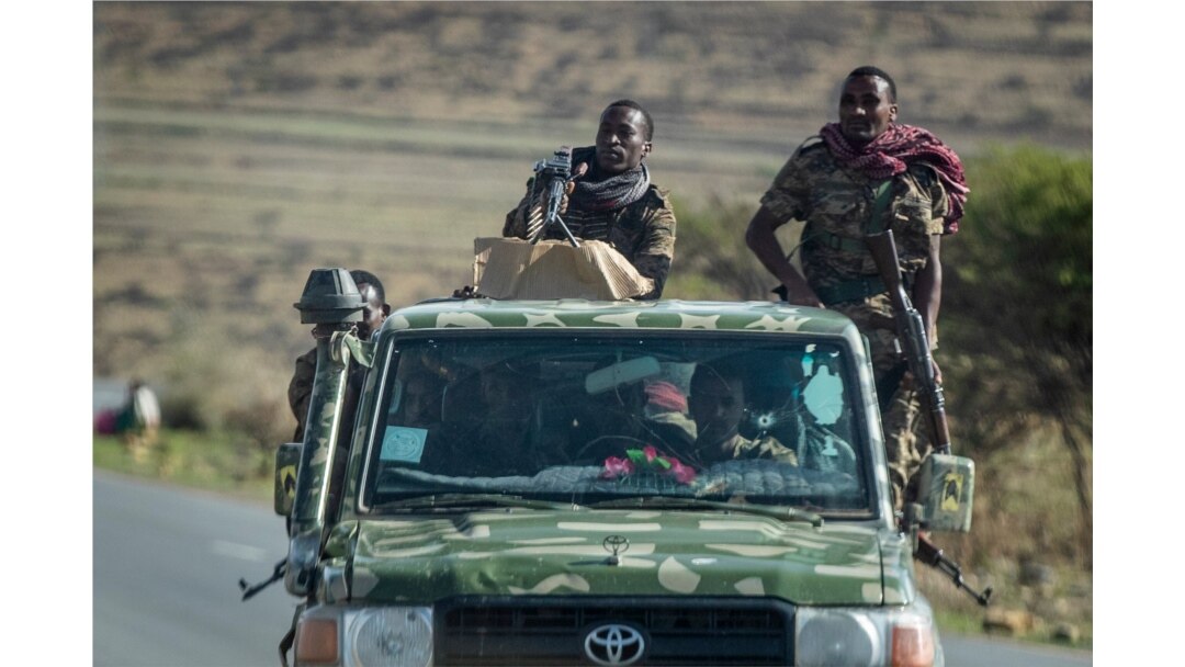 FILE - Ethiopian government soldiers ride in the back of a truck on a road near Agula, north of Mekele, in the Tigray region of northern Ethiopia, May 8, 2021.