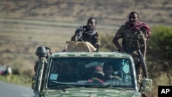 In this Saturday, May 8, 2021 file photo, Ethiopian government soldiers ride in the back of a truck on a road near Agula, north of Mekele, in the Tigray region of northern Ethiopia.