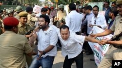 Indian policemen detain activists of Asomiya Yuva Mancha (AYM) during a protest against the lynching of a man accused of rape in front of Nagaland House in Gauhati, in the northeastern Indian state of Assam, Saturday, March 7, 2015.