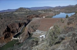 FILE - The Iron Gate Dam, powerhouse and spillway are on the lower Klamath River near Hornbrook, Calif., March 3, 2020.