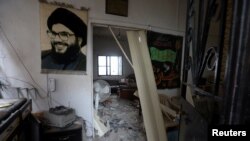 FILE - A picture of Lebanon's Hezbollah leader Sayyed Hassan Nasrallah hangs in a house that was damaged during Israeli shelling in recent weeks in Mhaibib village, near the border with Israel, southern Lebanon November 28, 2023.