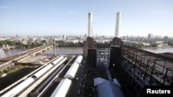 Two of the four iconic smokestacks of the former Battersea Power Station, which is to be redeveloped into retail units and housing by a Malaysian consortium, are seen in London, September 5, 2012. 
