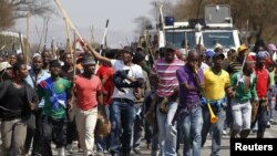 Mineworkers take part in a march outside the Anglo American mine in South Africa's North West Province, September 12, 2012. 