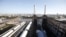 Two of the four iconic smokestacks of the former Battersea Power Station, which is to be redeveloped into retail units and housing by a Malaysian consortium, are seen in London, September 5, 2012. Grosvenor Bridge is at left. REUTERS/Neil Hall (BRITAIN - 