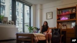 Sara Hunt, 19, a sophomore at New York University from Pigeon Forge, Tennessee, sits in her dorm room, Wednesday, Aug. 30, 2023, in New York. Hunt wanted her dorm room to look cozy but her budget was $100. 