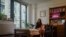 Sara Hunt, 19, a sophomore at New York University from Pigeon Forge, Tennessee, sits in her dorm room, Wednesday, Aug. 30, 2023, in New York. Hunt wanted her dorm room to look cozy but her budget was $100. 