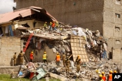 Rescuers work at the site of a building collapse in Nairobi, Kenya, June 13, 2017.