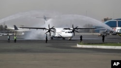 In this photo provided by Tasnim News Agency, a traditional water cannon salute welcomes an Iran Air's new commercial aircraft at Mehrabad airport in Tehran, Aug. 5, 2018. 