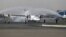 In this photo provided by Tasnim News Agency, a traditional water cannon salute welcomes an Iran Air's new commercial aircraft at Mehrabad airport in Tehran, Aug. 5, 2018. 