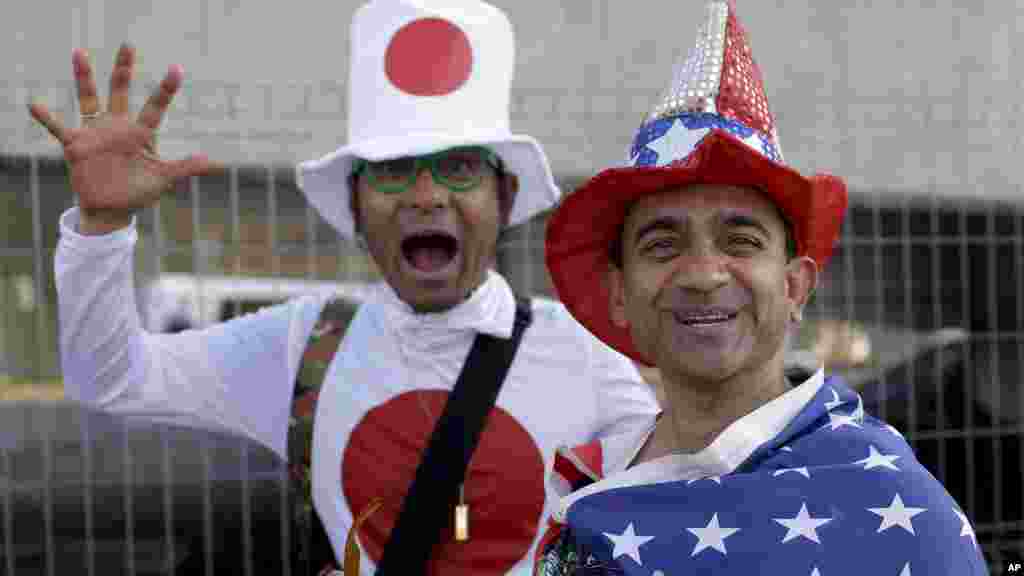 Fans from Japan and the United States walk toward the Maracana Stadium ahead of the opening ceremony for the 2016 Summer Olympics in Rio de Janeiro, Brazil, Aug. 5, 2016. (AP/Natacha Pisarenko)