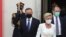 Poland's conservative President Andrzej Duda,left, and First Lady Agata Kornhauser-Duda, right leave the parliament building following the ceremony of Duda's swearing in for a second five-year term in Warsaw, Poland, August 6, 2020.