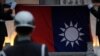 FILE - Honor guards lower a Taiwanese flag at Liberty Square, in Taipei, Taiwan, April 1, 2020.